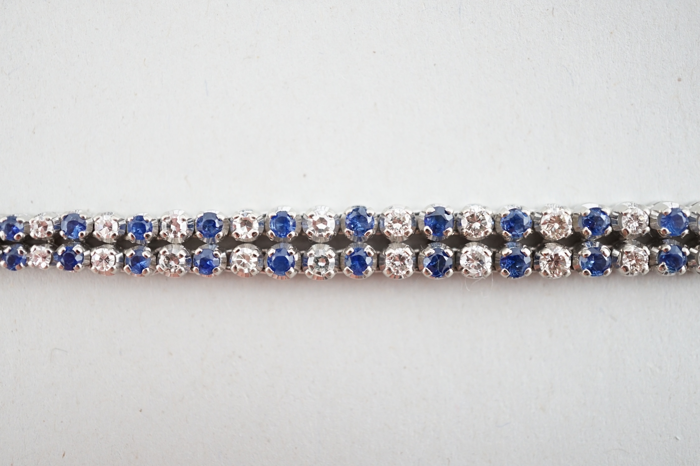 A 1960's 14ct white gold, sapphire and diamond two row line bracelet